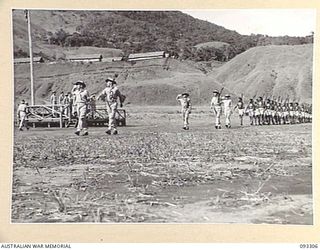 NADZAB AREA, NEW GUINEA, 1945-06-27. THE MARCH PAST OF A COMPANY, DEPOT BATTALION, PACIFIC ISLANDS REGIMENT, LED BY CAPT C.E. SCOTT, ADJUTANT (1). THE SALUTE WAS TAKEN BY HIS ROYAL HIGHNESS, THE ..