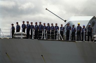 Sailors aboard the Halifax class Canadian frigate HMCS VANCOUVER (FFH 331), "man the rails" as the ship leaves Naval Station Pearl Harbor for sea exercises during RIMPAC 98