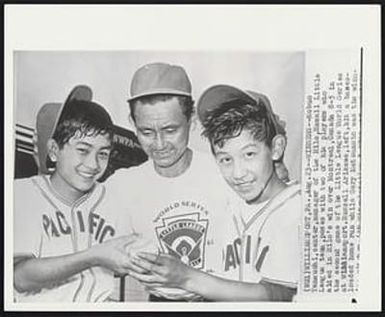 Winners - Nobuo Yamauchi, center, manager of the Hilo, Hawaii Little League team, poses with two of his players who aided in Hilo’s win over Montreal, Canada 8-5 in the second game of the Little League World Series at Williamsport. Russell Arikawa, left, hit a bases-loaded home run while Gary Matsumoto was the winn[ing pitcher]