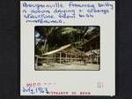 Bougainville farmer building a cocoa drying and storage structure from bush materials, Jul 1963