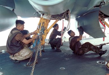 AIRMAN (AN) Tope Enriquez (left), of Yigotown, Guam, AN Claribel Urema (center), from Trenton, New Jersey and Aviation Machinist's Mate Third Class (AD3) Tomas Manuel, from San Francisco, California, hand wipe an F/A-18 Hornet as part of Fighter Squadron One Nine Two (VFA-192) Golden Dragons' Preventive Maintenance program