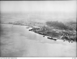 LAE, NEW GUINEA. 1944-03-30. AN AERIAL VIEW OF THE PORT SHOWING LAE AIRSTRIP IN THE LEFT BACKGROUND