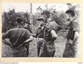 ULUPU, NEW GUINEA, 1945-07-10. BRIG M.J. MOTEN, COMMANDING OFFICER, 17 INFANTRY BRIGADE (1), EXAMINING A JAPANESE SWORD CAPTURED BY 16 PLATOON, D COMPANY, 2/5 INFANTRY BATTALION, DURING THEIR ..