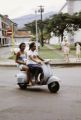 French Polynesia, women driving scooter in Papeete