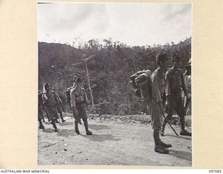 MOUNT SHIBURANGU, WEWAK AREA, NEW GUINEA. 1945-09-21. JAPANESE STAFF OFFICERS OF 18 JAPANESE ARMY, LOADED DOWN WITH PERSONAL GEAR APPROACHING THE ASSEMBLY POINT AT MAKOW ON TOP OF MOUNT SHIBURANGU ..