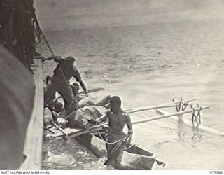 WUNUNG PLANTATION, NEW BRITAIN. 1944-12-30. VX46450 LIEUTENANT J. L. FLUCKER, 1ST NEW GUINEA INFANTRY BATTALION, LEAVING THE RAN VESSEL, ML802, AFTER CONFERRING WITH GENERAL OFFICER COMMANDING, 5TH ..