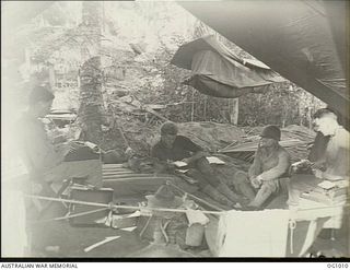 AITAPE, NORTH EAST NEW GUINEA. C. 1944-04. WAR CORRESPONDENTS SENT NEWS OF THE GREAT PART PLAYED BY RAAF GROUND FORCES IN THE AITAPE LANDING RIGHT ROUND THE WORLD. "DOC" QUIGG OF UNITED PRESS, F. ..