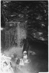 People, including Keesing's daughters, in pool of water, waterfall