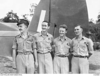 VIVIGANI, GOODENOUGH ISLAND, PAPUA. 1944-01-18. AN INFORMAL GROUP PORTRAIT OF WEST AUSTRALIANS WITH NO. 6 (BEAUFORT) SQUADRON RAAF, THE ONLY ALL-AUSTRALIAN CREW IN THE SQUADRON. BESIDE THE TAIL OF ..