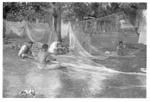 Fishermen repairing nets in Vai'uli's 'api