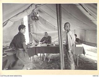 CAPE WOM, NEW GUINEA. 1945-10-19. LIEUTENANT TAZAKI, OF THE JAPANESE ARMY, BEING QUESTIONED AT HEADQUARTERS 6 DIVISION BY THE WEWAK WAR CRIMES COMMISSION, WHICH IS TAKING SUMMARIES OF EVIDENCE FOR ..