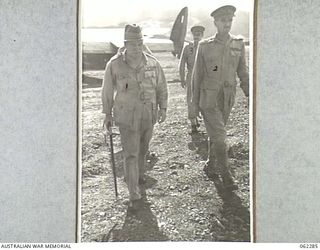 DUMPU, NEW GUINEA. 1943-12-19. VX1 GENERAL SIR THOMAS BLAMEY, GBE., KCB., CMG., DSO., ED., COMMANDER-IN-CHIEF, ALLIED LAND FORCES SOUTH WEST PACIFIC AREA (1) BEING ESCORTED FROM HIS AIRCRAFT BY VX9 ..