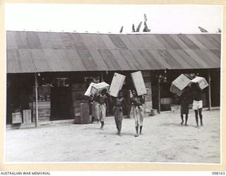 TOROKINA, BOUGAINVILLE. 1945-10-19. NATIVES WORKING AT THE ASSISTANT DIRECTOR ORDNANCE SERVICE DUMP, 3 DIVISION