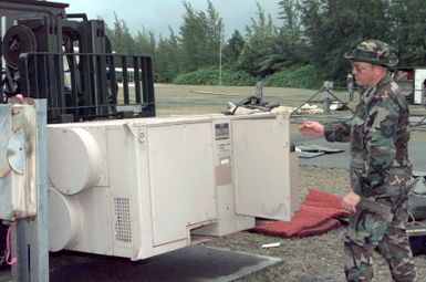 US Air Force MASTER Sergeant John Curnin, 36th Civil Engineer Squadron, Andersen Air Force Base, Guam, hooks up climate control units to tents erected to house airmen from the 96th Bomb Squadron and support personnel from the 2nd Bomb Wing, Barksdale Air Force Base, Louisiana. The airmen are deployed to Naval Station Diego Garcia in support of Operation DESERT THUNDER 2