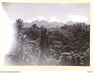 MOROKAIMORO, BOUGAINVILLE, 1945-06-12. THE SCENIC VIEW LOOKING NORTH EAST, SHOWING THE SOUTHERN END OF THE CROWN PRINCE RANGE IN THE BACKGROUND. TROOPS OF 2/8 COMMANDO SQUADRON, OPERATE FROM THIS ..