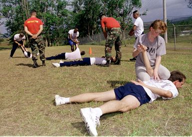 During their three week training, Auxiliary Security Force academy students, including US Army SPECIALIST (SPC) Sarah Dye (right), practice "wrist lock take-down" techniques with instructor US Navy GUNNER's Mate 2nd Class (GM2) David M. Martino attached to Explosive Safety, Commander US Naval Forces , Marianas (ComNavMarianas), Guam, 6 May 1998