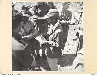 KAIRIRU ISLAND, NEW GUINEA, 1945-09-11. JAPANESE MEDICAL OFFICER AND OFFICERS OF 6 DIVISION DISCUSSING MEDICAL SUPPLIES. FOLLOWING THE SURRENDER OF THE JAPANESE AN ADVANCE PARTY OF 63 OFFICERS AND ..