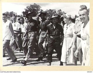 TOROKINA, BOUGAINVILLE, 1945-08-16. THE ENGLISH SINGER GRACIE FIELDS BEING ACCOMPANIED FROM WARD TO WARD BY WALKING PATIENTS DURING HER VISIT TO 2/1 GENERAL HOSPITAL