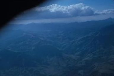 [Aerial view of forest covered mountains in Fiji]