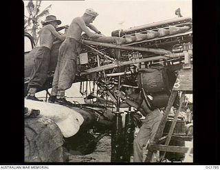 MOMOTE, LOS NEGROS ISLAND, ADMIRALTY ISLANDS. C. 1944-04. IT DOESN'T TAKE LONG FOR THE SHIP THAT CRACKED UP ON THE RUNWAY TO BE CARTED OFF AND DISSEMBLED. IT WILL BE COMPLETELY REBUILT. HERE THE ..