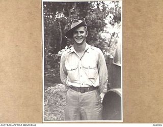 DREGER HARBOUR, NEW GUINEA. 1943-12-06. FIRST LIEUTENANT DELBERT C. HURD OF NEBRASKA, USA, AND OF THE 870TH UNITED STATES AVIATION ENGINEER BATTALION, POSING IN A "DIGGER'S HAT"