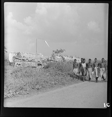 Group of young local men and the remains of old Junker aeroplanes, Kerowagi, Simbu, Papua New Guinea