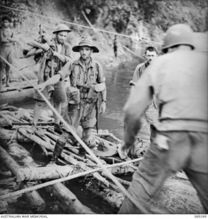 KALIKODOBU, NEW GUINEA. 1942-10. THE PARTY OF THE 2/14TH INFANTRY BATTALION ARRIVING AT THE UNITED STATES BASE CAMP. THESE MEN WERE CUT OFF FROM THE MAIN BODY OF TROOPS DURING THE WITHDRAWAL ACROSS ..