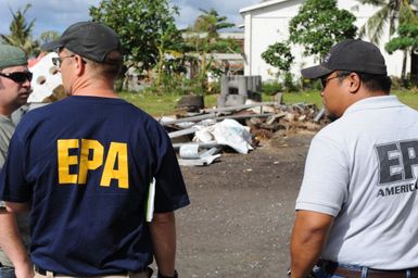 Earthquake ^ Tsunami - Pago Pago, American Samoa, October 2, 2009 -- Chris Reiner, U. S. Environmental Protection Agency and a representative from American Samoa Environmental Protection Agency observe a hazardous waste collection center. The containment of hazardous waste is an important step in the removal of debris.