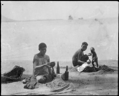 Man, woman and child, collecting water, Rabaul, New Guinea, ca. 1929 / Sarah Chinnery