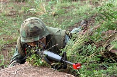 Lance Corporal Martin of Company A, Battalion Landing Team 1/3, arms his M16 rifle at"enemy attackers"during Operation KERNAL BLITZ