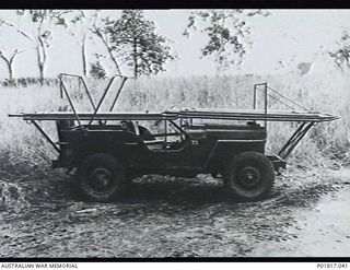 Probably  Goodenough Island, D'Entrecasteaux Islands, Papua, 1944. A jeep modified to serve as an ambulance, possibly for No. 5 Medical Receiving Station RAAF. The vehicle has been fitted with a ..