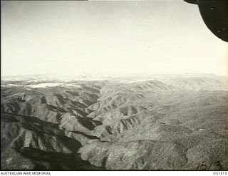 CENTRAL NEW GUINEA HIGHLANDS. C. 1944-08. AERIAL VIEW OF MOUNTAINOUS COUNTRY BETWEEN MERAUKE AND TADJI SEEN FROM A LOCKHEED LODESTAR AIRCRAFT OF NO. 37 SQUADRON RAAF