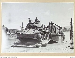 TOROKINA AREA, BOUGAINVILLE, 1945-08-06. THE M24 GENERAL CHAFFEE LIGHT TANKS GOING ABOARD AUSTRALIAN LANDING CRAFT 40 IN THE HARBOUR DURING TESTS CONDUCTED FOR THE WAR OFFICE