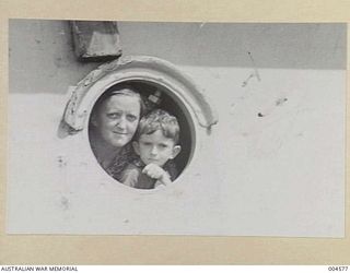 RAIDER VICTIMS ARRIVE IN AUSTRALIA AFTER HAVING THEIR SHIPS HAD BEEN SUNK AND THEY HAD BEEN LANDED ON ISL. OF EMIRAU - MRS. LANGAR AND ONE OF HER TWO SMALL SONS. MRS. LANGAR'S OTHER SON WAS A ..