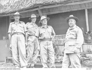 PORT MORESBY, NEW GUINEA. 1943-12-28. VX1 GENERAL SIR THOMAS BLAMEY GBE KCB CMG DSO ED, COMMANDER-IN-CHIEF, ALLIED LAND FORCES, SOUTH WEST PACIFIC AREA, WITH SOME OF HIS SENIOR OFFICERS OUTSIDE HIS ..