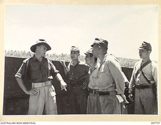 MUSCHU ISLAND, NEW GUINEA. 1945-10-10. LIEUTENANT COLONEL A.W. BUTTROSE, COMMANDING OFFICER 2/5 INFANTRY BATTALION, TALKING TO JAPANESE OFFICERS DURING A TOUR OF THE JAPANESE COMPOUND BY MAJOR E.S. ..