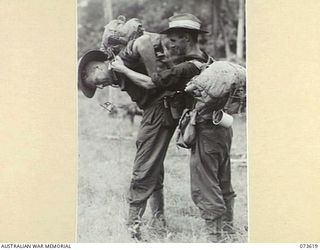 NX58247 SERGEANT A. FRAZER, OFFICIAL PHOTOGRAPHER, MILITARY HISTORY SECTION, HEADQUARTERS NEW GUINEA. FORCE, ASSISTS MR. N. BROWN (1), OFFICIAL PHOTOGRAPHER, AUSTRALIAN DEPARTMENT OF INFORMATION , ..