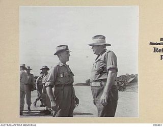 JACQUINOT BAY, NEW BRITAIN. 1945-04-09. SENATOR J.M. FRASER, ACTING MINISTER FOR THE ARMY (1), GREETING WO II C.F. COLLINS, BASE CENSOR (2), SHORTLY BEFORE LEAVING THE HQ 5 DIVISION AREA BY RAAF ..
