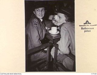 SYDNEY, NEW SOUTH WALES, 1945-10-02. SISTER J. ANDERSON, AUSTRALIAN ARMY NURSING SERVICE, OF "L" FORCE, WHO WAS CAPTURED BY THE JAPANESE AT RABAUL, NEW BRITAIN, ENJOYING A GOOD CUP OF TEA AND A ..