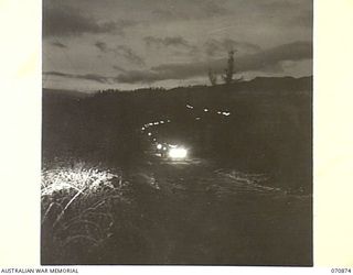 WAU, NEW GUINEA, 1944-02-23. A 44-VEHICLE CONVOY FROM THE 2/34TH GENERAL TRANSPORT COMPANY LEAVING WAU FOR BULLDOG AT 0700 HOURS TO RETURN BY THE REINHOLD HIGHWAY. TRAVELLING AT AN AVERAGE SPEED OF ..