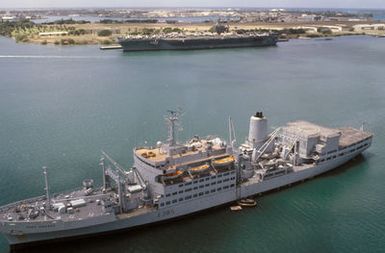 An aerial port bow view of the British fleet replenishment ship HMS FORT GRANGE (A 385) and the nuclear-powered aircraft carrier USS CARL VINSON (CVN 70) in the harbor during Exercise RIMPAC '86