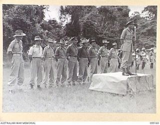 LAE, NEW GUINEA, 1945-12-01. COLONEL G.H.S. MORAN ADDRESSING A PARADE OF TROOPS OF 2/1 BASE WORKSHOP AND THEIR ATTACHMENTS, WHICH INCLUDED TROOPS OF 2/77 LIGHT AID DETACHMENT ON THE OCCASION OF THE ..