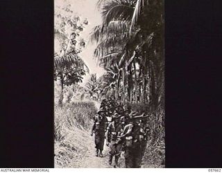 KAIAPIT, NEW GUINEA, 1943-09-27. HEADQUARTERS, 21ST AUSTRALIAN INFANTRY BRIGADE MOVING ALONG THE TRACK FROM KAIAPIT IN THE MARKHAM VALLEY. SHOWN: WARRANT OFFICER 2 PERAZZO (1); PRIVATE (PTE) PALMER ..