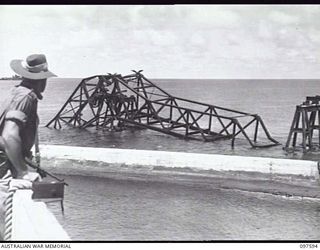 OCEAN ISLAND. 1945-09-30. THE CANTILEVER WHARF WHICH WAS WRECKED BY ALLIED FORCES BEFORE IT FELL INTO JAPANESE HANDS, VIEWED FROM HMAS DIAMANTINA