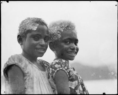 Two young girls, wearing European style clothing with limed hair, New Guinea, ca. 1929 / Sarah Chinnery