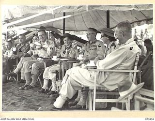 LAE, NEW GUINEA. 1944-08-27. THE OFFICIAL PARTY RELAX AT AFTERNOON TEA DURING THE SURF CARNIVAL ORGANISED BY HEADQUARTERS, 5TH DIVISION AT MALAHANG BEACH. IDENTIFIED PERSONNEL ARE:- VX45322 COLONEL ..