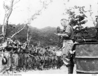 But, New Guinea. May 1945. Church service of thanksgiving to celebrate victory in Europe was conducted by Padre A. E. Bottrell on the beach for members of the 6th Australian Division on the eve of ..