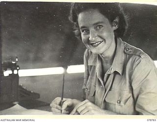 BOUGAINVILLE ISLAND. 1945-01-29. WFX17050 LANCE CORPORAL K. WELLS, AUSTRALIAN ARMY MEDICAL WOMEN'S SERVICE, WORKING IN THE GENERAL OFFICE OF THE 21ST AUSTRALIAN GENERAL HOSPITAL