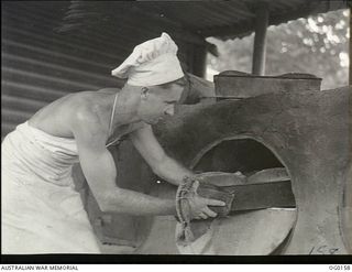 VIVIGANI, GOODENOUGH ISLAND, PAPUA NEW GUINEA. C. 1943-07. 13205 LEADING AIRCRAFTMAN A. H. HALL OF MOOROOPNA, VIC, BAKER OF NO. 7 MOBILE WORKS SQUADRON RAAF, BAKING THE DAILY BREAD FOR THE UNIT