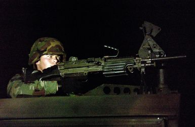 U.S. Air Force 36 Security Forces Squadron, 36 Air Expeditionary Wing AIRMAN First Class Anthony Northern guards his post with a 7.62 mm M-249 machine gun during exercise Beverly Bearcat at Andersen Air Force Base, Guam, on Dec. 3, 2004.(U.S. Air Force PHOTO by AIRMAN First Class Kristin Ruleau) (Released)